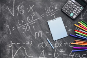notepad calculator with felt pens arranged written chalkboard